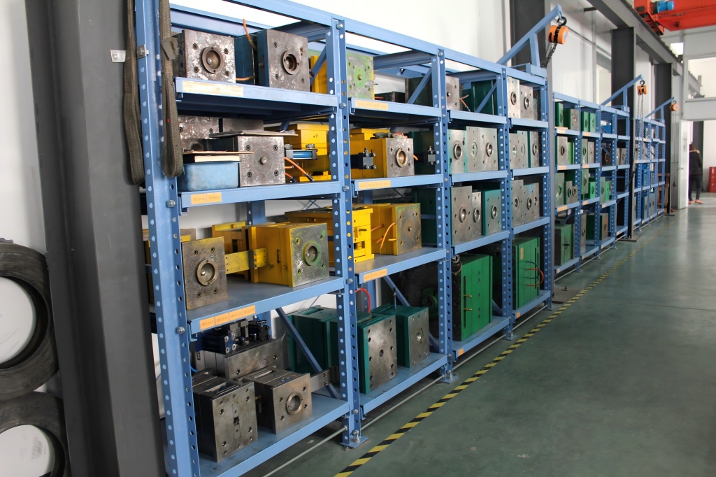 A factory mold storage area with multiple injection molds used for dog brush manufacturing